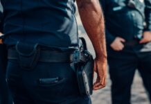 „Îți tai gâtul cu un briceag!” Un bărbat a amenințat un polițist și i-a tras un picior în cap, deși era încătușat. Bodycam-ul a înregistrat totul